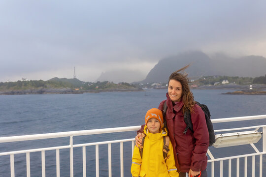 People, enjoying ferry ride between Bodo and Lofoten Moskenesoya summertime, child and adults on a ferry on sunset