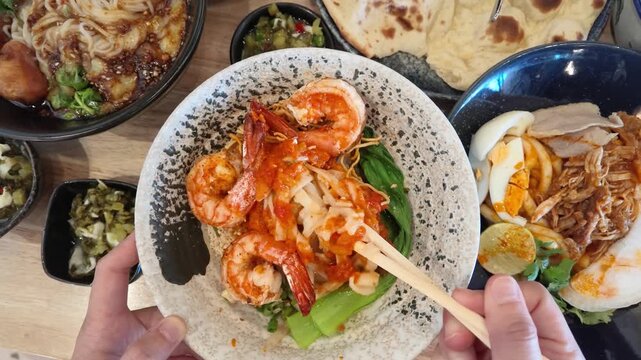 Overhead View of Person Eating Burmese Shan Noodles with Prawns