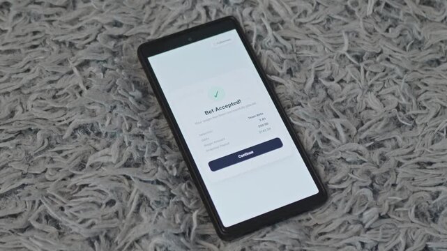 Smartphone screen displaying sports betting app interface with successful bet confirmation for online gambling concept