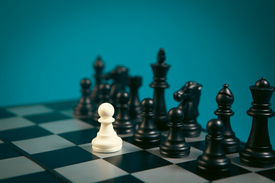 Chess board with black and white chess pieces on blue background.