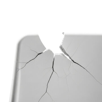 Macro Shot of a Shattered and Cracked White Object with Radial Fractures on White Background