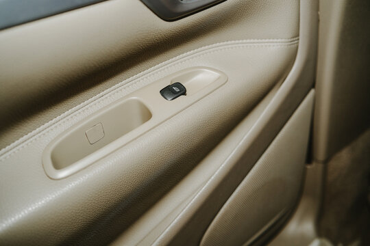Car door panel with window control button and storage compartment