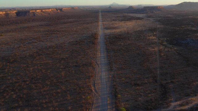 Ugab valley arid landscape near the Fingerklippe rock formation at sunset, Revealing drone shot