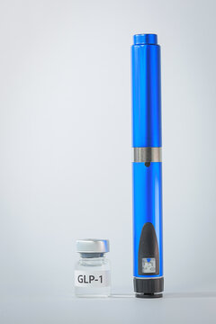 Blue injection pen standing next to glass vial offers reassuring medical medication therapy for effective weight management health