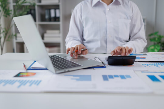 Business woman analysis summary graph reports of business operating expenses and work data about the company's financial statements.