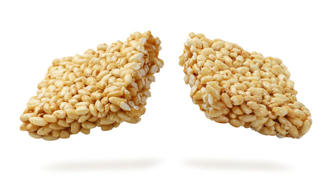 Puffed rice broken in half flies close-up on a white. Isolated