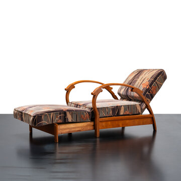 1930s reclining armchair, featuring a wooden frame with curved armrests and an adjustable mechanism.