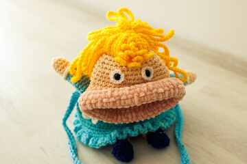Fototapeta premium Crochet doll with big mouth. This photo has been taken in Kladno, Czech Republic, August 2026