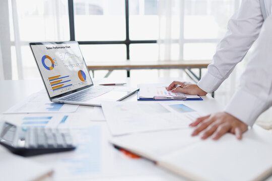 Business woman analysis summary graph reports of business operating expenses and work data about the company's financial statements.
