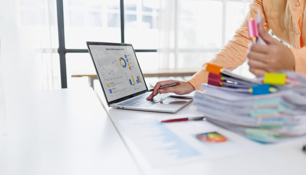 Businesswoman or accountant conducting an analysis of financial reports on a laptop, emphasizing the utilization of digital tools for data interpretation and informed decision-making.