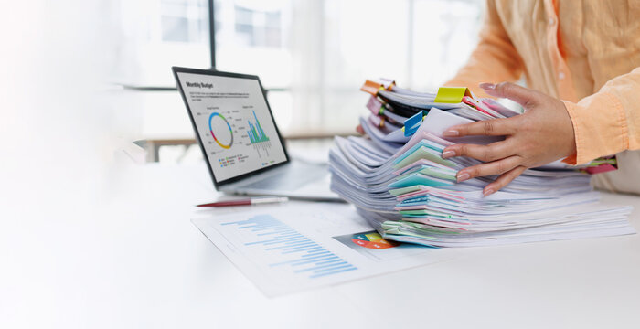 Businesswoman or accountant conducting an analysis of financial reports on a laptop, emphasizing the utilization of digital tools for data interpretation and informed decision-making.