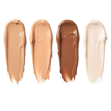 Four shades of foundation makeup are displayed in smooth elongated smears against a black background
