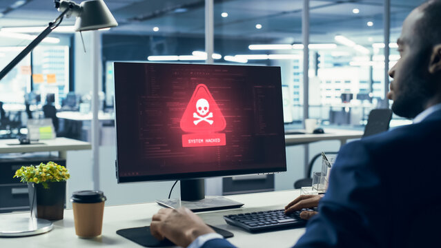 Office Male Professional Watches His Workstation Get Hacked as Malware Virus Popups Show Ransomware Encryption, Credential Theft, Data Threats to Corporate Systems and Business Cyber Attack