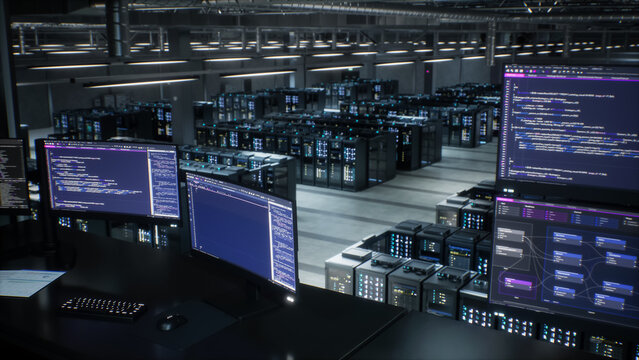 Control Room Workstation Monitors an AI Data Center, Screens Showing Infographics, Code and Network Node Maps While Gpu Server Racks Fill Hyperscale Facility Warehouse