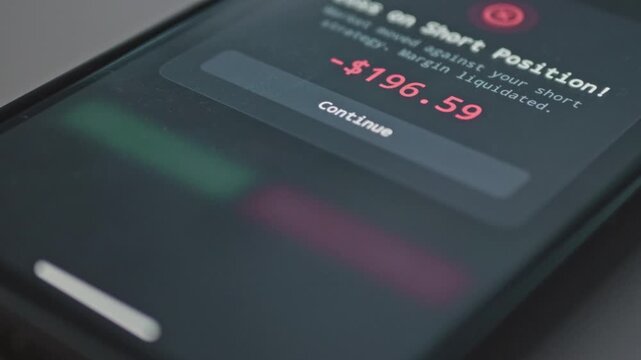 Close up of mobile phone screen showing margin liquidated error message after unsuccessful short trade, suitable for financial risk education, trading mistake tutorials, and bear market footage.