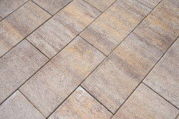 Top down view of rectangular beige concrete paving tiles pattern on sidewalk background. Real Photo © LariBat