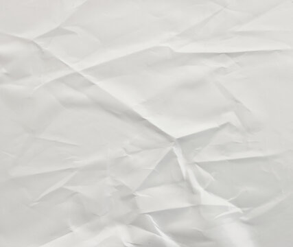 Background of white textured paper with crumples. Poster or sticker with pattern