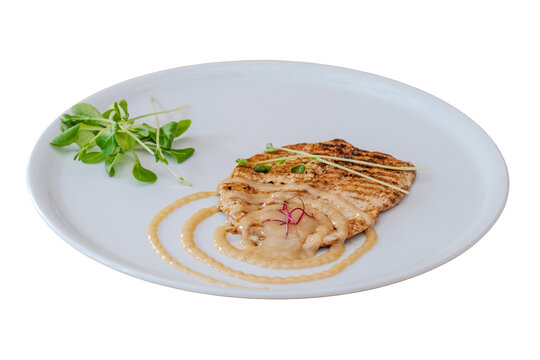Grilled chicken steak with sauce and microgreens on plate
