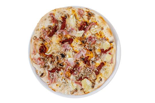 Delicious pizza with ham, mushrooms, sun dried tomatoes, and sunflower seeds