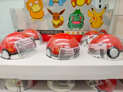 Malang, Indonesia - July 24, 2026: Close-up view of A retail display stand featuring Pok&eacute;mon "Palmsize Wonders" Pok&eacute; Ball blind capsules. Funism.