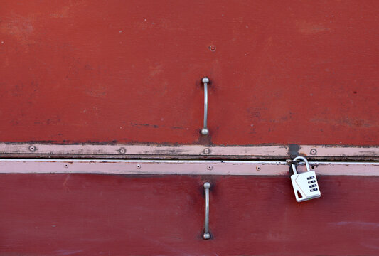 Red metal door secured with combination lock