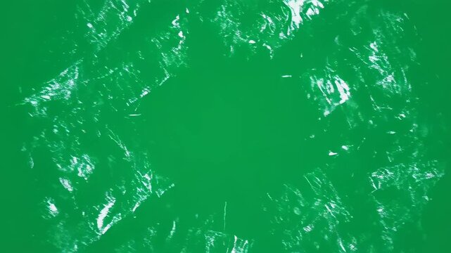 Green background with white diamond patterns and black horizontal