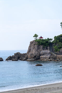 View of Kaizumi Shrine (Ryuo Shrine) perched on Ryuzu Cape at Katsurahama in Kochi, Japan.