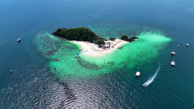 Aerial view of Koh Khai Nok island with white sandy beaches, turquoise waters, and boats anchored offshore in Phru Nai, Phang Nga, Thailand.