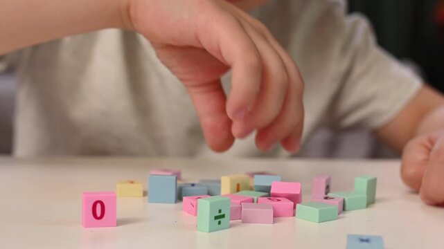 Child Learning Basic mathematics with Colorful Blocks, Early Education, STEM, Homeschooling, Preschool Math, Numeracy Skills, blurred closeup hands