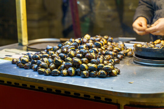Freshly roasted chestnuts on a street food stall