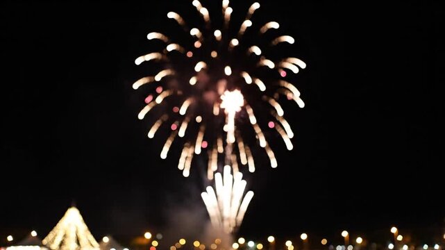 Green firework burst over city fairground at night