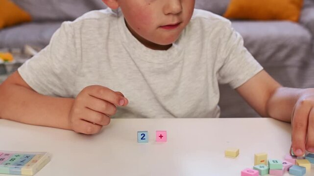 Child Learning Basic mathematics with Colorful Blocks, Early Education, STEM, Homeschooling, Preschool Math, Numeracy Skills, blurred closeup hands