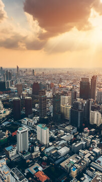 Bangkok city skyline at sunset with modern buildings, downtown urban panorama of Thailand capital with skyscrapers and evening sky, aerial drone view