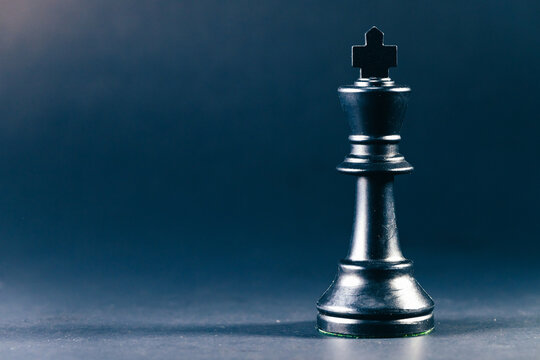 Black chess pieces on dark background for business strategy metaphor. conceptual metaphor for business strategy corporate planning tactics competition success power and leadership 