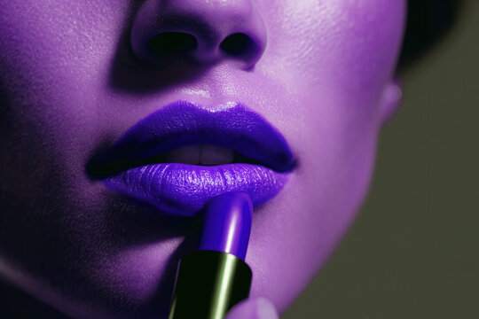 Close-up of Woman Applying Purple Lipstick to Lips