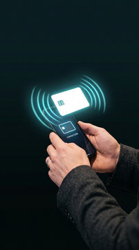 Hands holding a smartphone with a contactless payment interface and a blank white card, symbolizing modern financial transactions, technology, and convenience