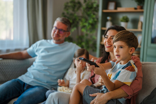 Family relaxing together on couch watching television
