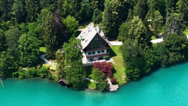 Drone Shot of Lakefront Villa on Lake Bled, Slovenia. House With Garden and Dock in Green Forest