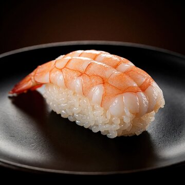 Fresh ebi shrimp nigiri sushi served on black plate. Traditional japanese seafood dish with cooked shrimp over vinegared rice. Gourmet culinary art for fine dining restaurant menu asian cuisine food