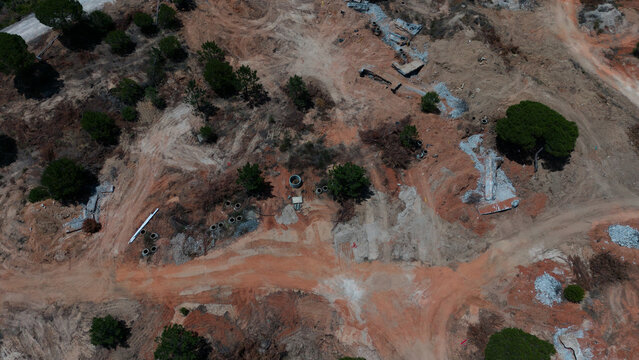 Aerial view of construction site for solar panels farm and machinery in progress