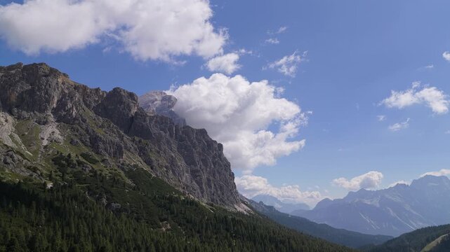 Aerial view of the rugged peaks and lush pine forests surrounding Passo Falzarego in Cortina d'Ampezzo, Veneto, Italy.