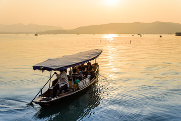 Sightseeing Boats on the Lake at Sunset, West Lake, Hangzhou, Zhejiang, China © 墨枫