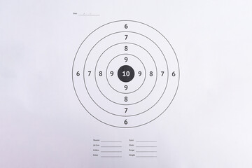 Flat Lay of Clean Paper Shooting Target with Unfilled Score Card © Queenmoonlite Studio