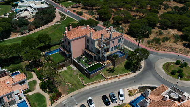 Aerial drone footage, shooting the tourist village of Vale de Lobo, on the shores of the Atlantic Ocean, golf courses for tourists. Portugal, Algarve.