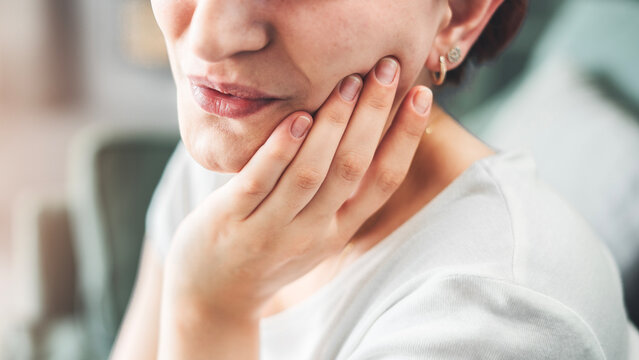 Young woman suffering from toothache