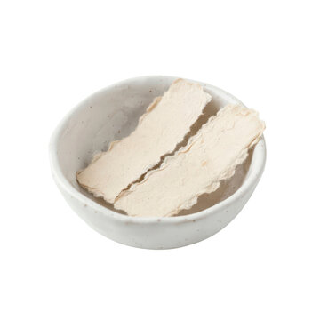 Dried tofu sheets in a ceramic bowl isolated on transparent background