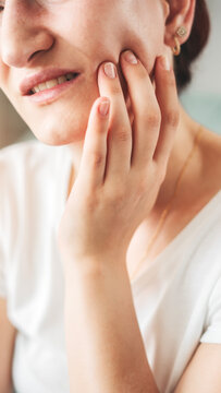 Young woman suffering from toothache