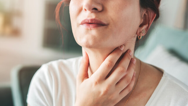Young woman suffering from sore throat