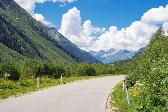 The view on the top of Dombai mountain  North Caucasus, Russia. Road at the foot of the mountains
