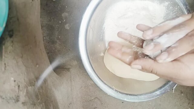 Hands Kneading Dough Ball for Making Indian Roti in Kitchen